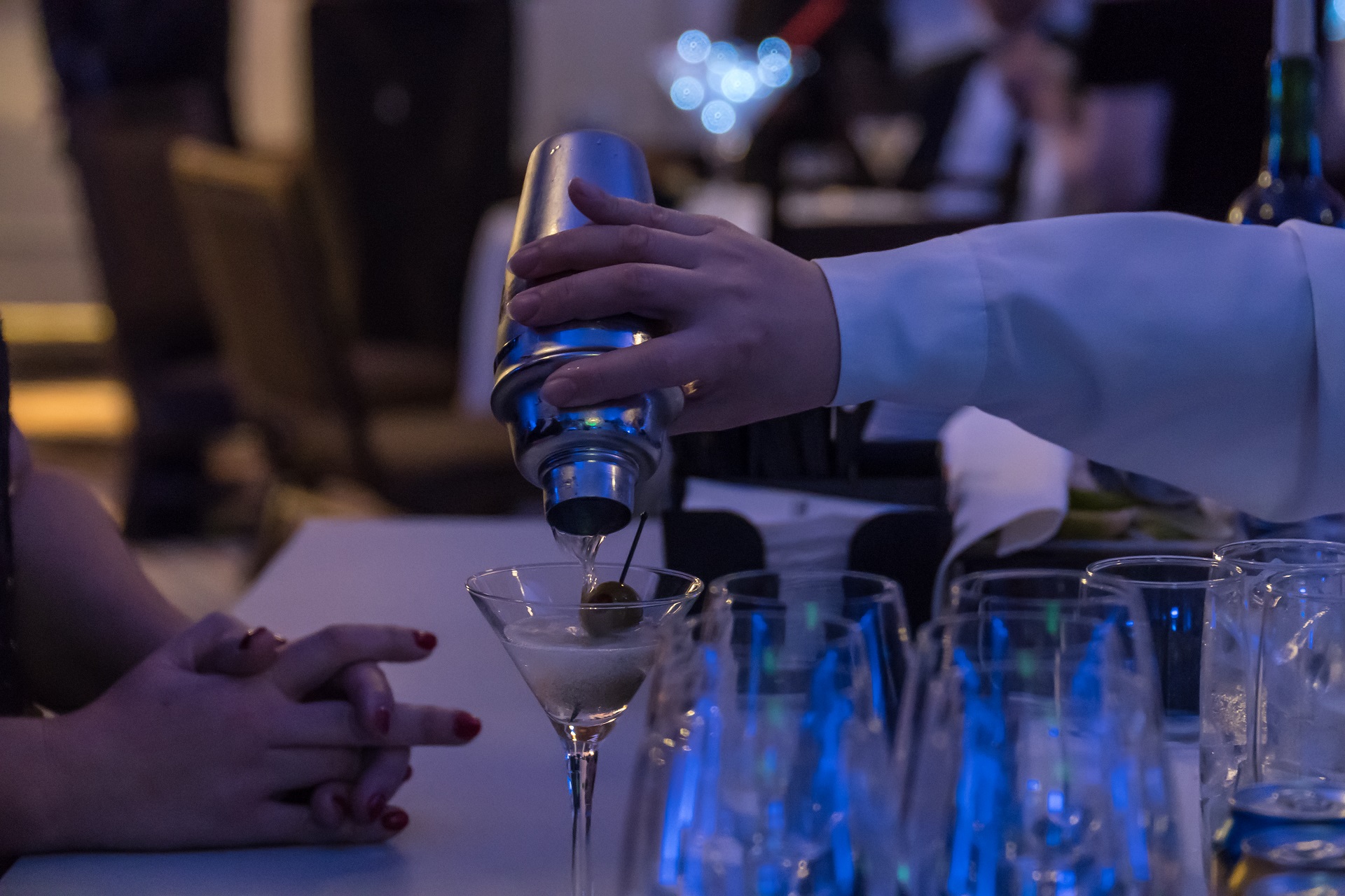 man pouring martini at casino party