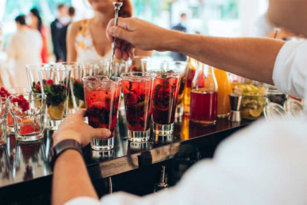 Bartender mixing berry drinks